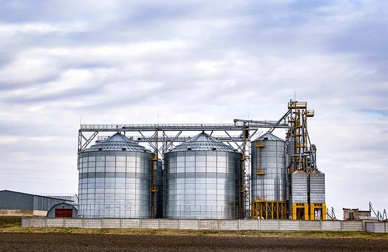 Paper mill with yellow overhead crane and large paper rolls