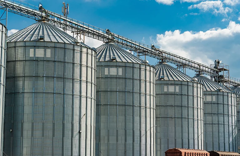 Paper mill with yellow overhead crane and large paper rolls